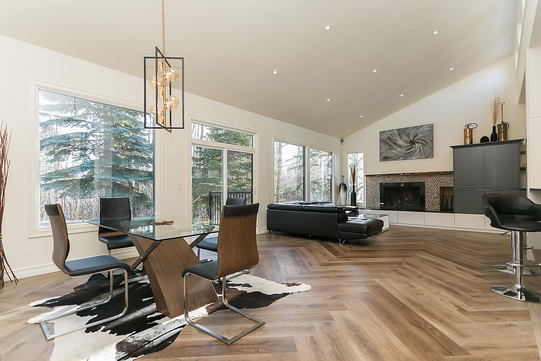 Bright dining room with herringbone pattern luxury vinyl plank flooring and modern decor