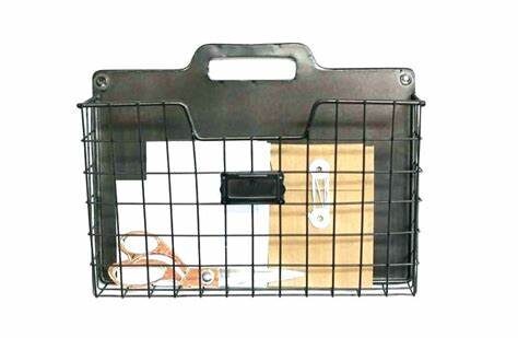Black wire mesh file organizer with folders placed on a white surface